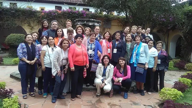 Members and partner organizations gathered in the courtyard of a large old house
